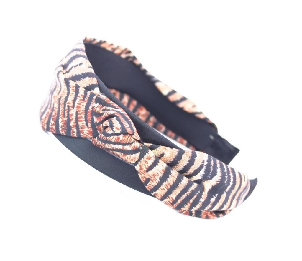 Wide Headband Covered With Animal Looking Fabric Of Black And Brown Nature Tied Into A Stylish Bow